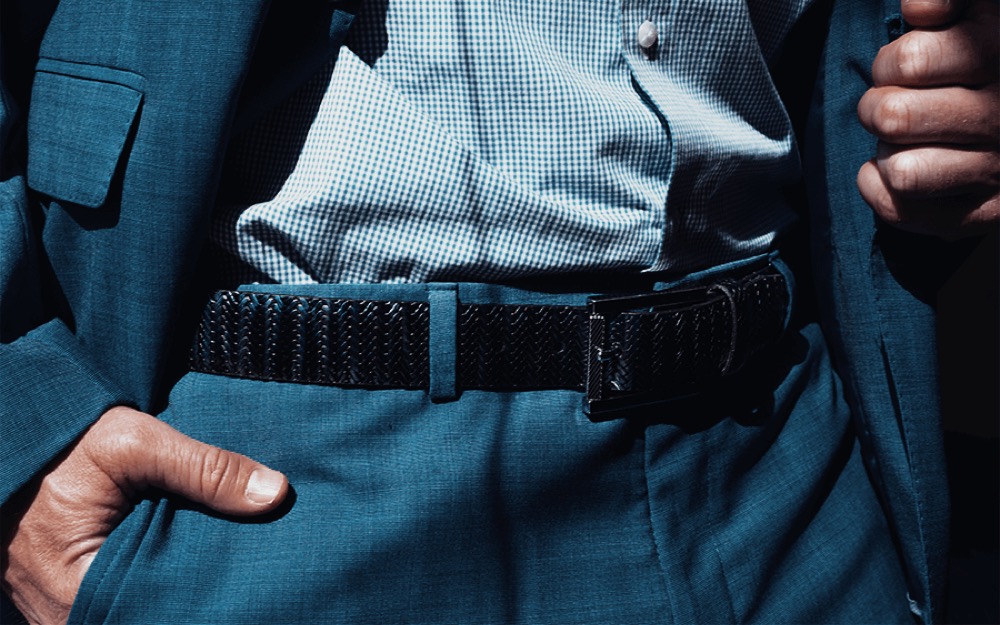 Three Remo Tulliani textured leather belts stacked, in black, brown and tan